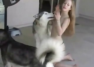 Skinny young girl playing with her dog