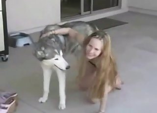 Skinny young girl playing with her dog