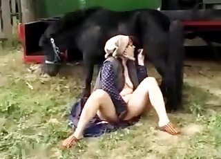 The dick of a pony is sucked of by a filthy farm slut that masturbates