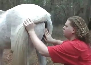 Fat guy pounds a white horse